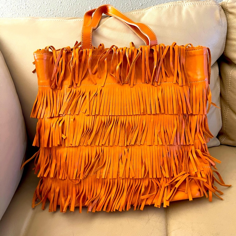 Guia’s orange fringe leather bag